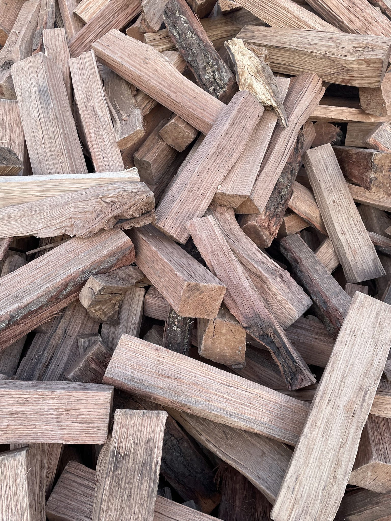 Stacked kiln-dried all Oak firewood logs ready to burn for fireplaces and fire pits