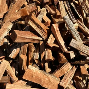 Stacked kiln-dried Cherry firewood logs ready to burn for fireplaces and fire pits