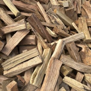 Stacked kiln-dried mixed firewood logs ready to burn for fireplaces and fire pits