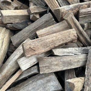 Stacked seasoned firewood logs ready to burn for fireplaces and fire pits