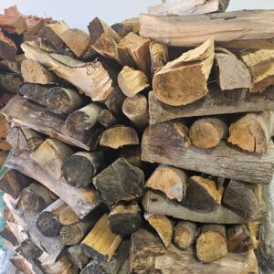 Stacked walnut firewood logs seasoned and ready for fireplace use